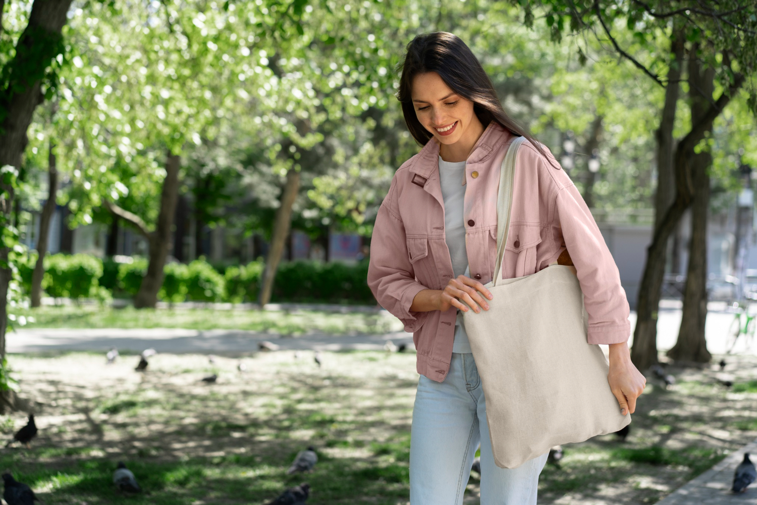 Woman walking with a plain tote bag in park